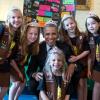 President Barack Obama wears a crown as he poses with Avery Dodson, Natalie Hurley, Miriam Schaffer, Claire Winton, and Lucy Claire Sharp, all 8-year-old members of Girl Scouts Troop 2612, from Tulsa, Oklahoma. The girls exhibited a Lego flood proof bridg