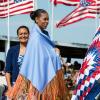 While visiting Standing Rock Sioux Tribe Reservation in Cannon Ball, North Dakota, First Lady Michelle Obama wears a shawl presented to her by Tribe Chairman Dave Archambault II and Mrs. Nicole Archambault during the Cannon Ball Flag Day Celebration, June