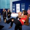 First Lady Michelle Obama is picked up by U.S. Olympic wrestler Elena Pirozhkova during a greet with Team USA Olympic athletes competing in the 2012 Summer Olympic Games, at the U.S. Olympic Training Facility at the University of East London in London, En