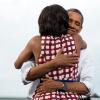President Barack Obama hugs First Lady Michelle Obama after she introduces him at a grassroots campaign event at Lagomarcino's Confectionary in Davenport, Iowa, August 15, 2012. 