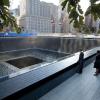 President Barack Obama and First Lady Michelle Obama, along with former President George W. Bush and former First Lady Laura Bush, pause at the North Memorial Pool of the National September 11 Memorial in New York, New York, on the tenth anniversary of th