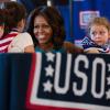First Lady Michelle Obama talks with children at the USO Warrior and Family Center in Fort Belvoir, Virginia, September 11, 2013. The center supports wounded, ill, and injured troops, their families, and caregivers, as well as local active duty troops.