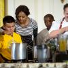 First Lady Michelle Obama and Chef Thomas Ciszak join school children in preparing the annual fall harvest meal in the East Room of the White House, October 14, 2014.