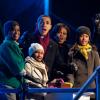 President Barack Obama, with mother-in-law Marian Robinson, daughters Sasha and Malia, and First Lady Michelle Obama, react as they push the button to light the National Christmas Tree during a ceremony on the Ellipse in Washington, D.C., December 9, 2010